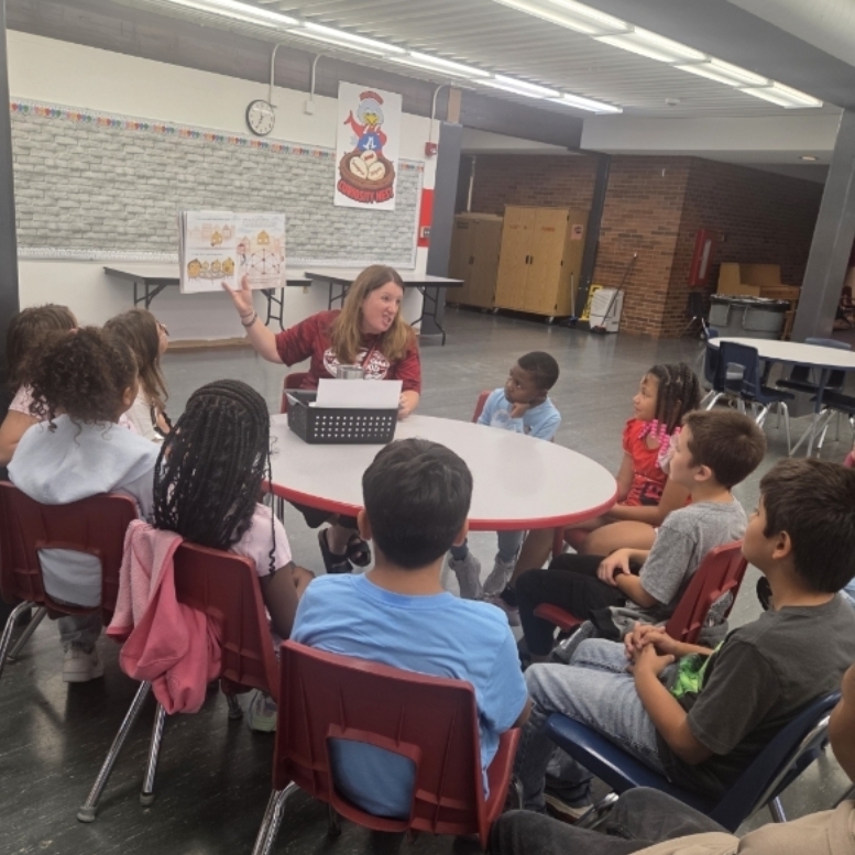 principal reads book to students