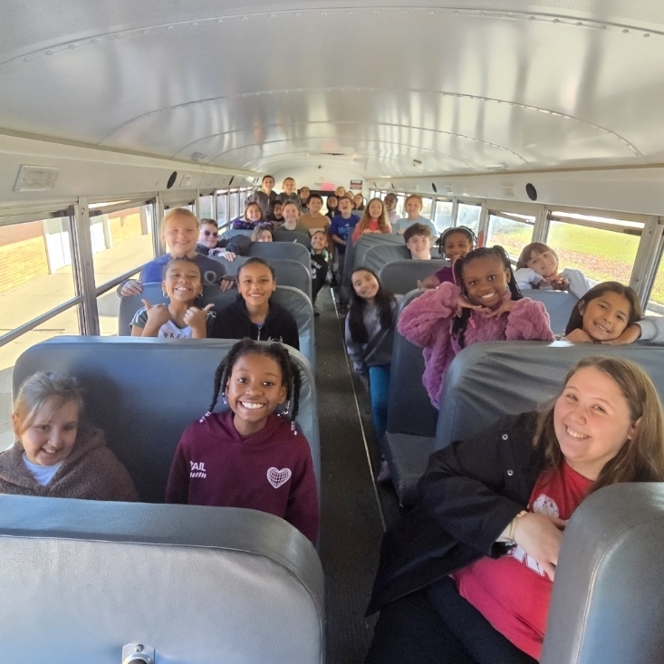 students smile on bus