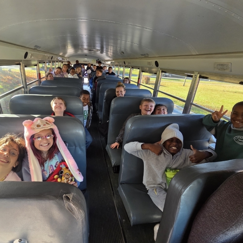 students smile on bus