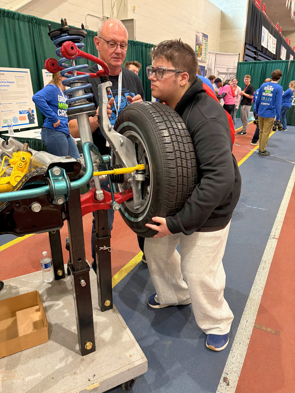 student changing tire