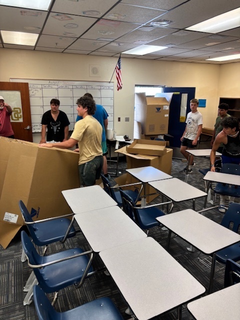 boys bringing in boxes