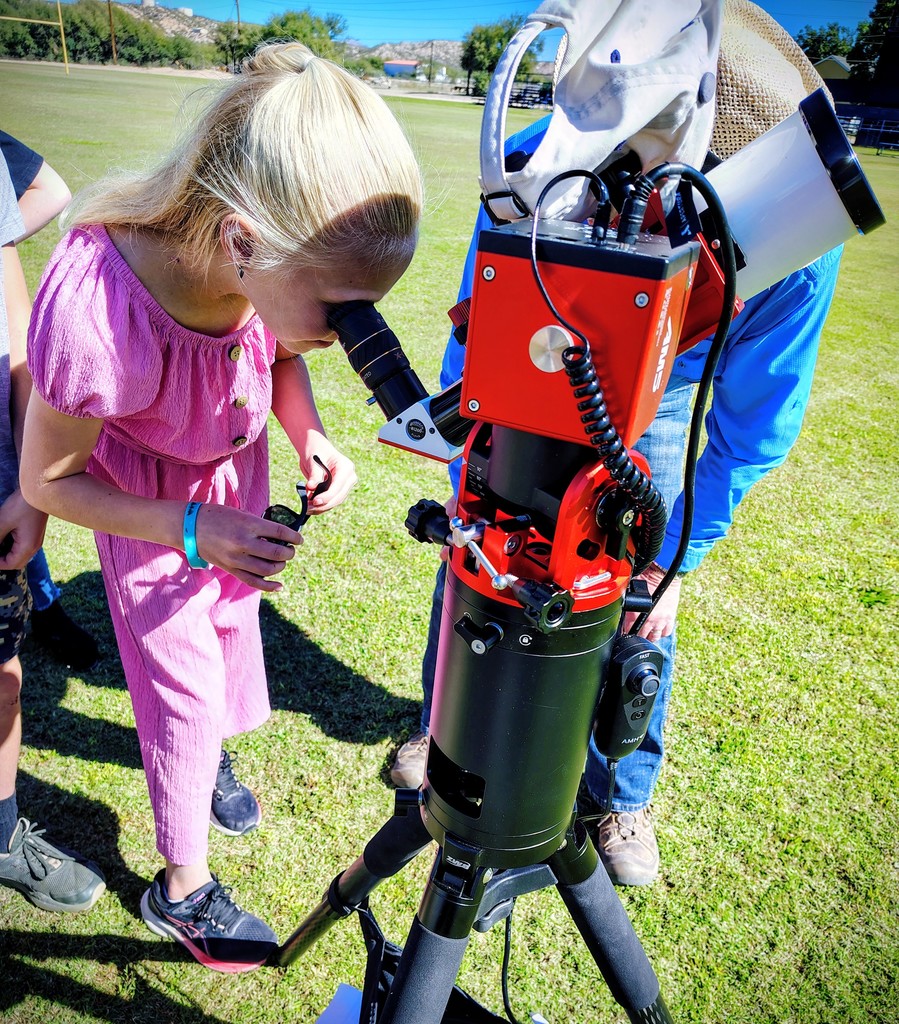 student looking in telescope