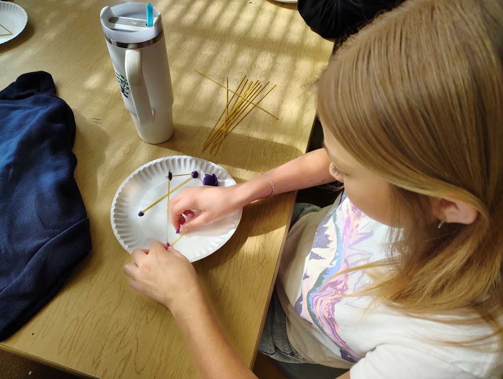 Student crafting a spaghetti tower