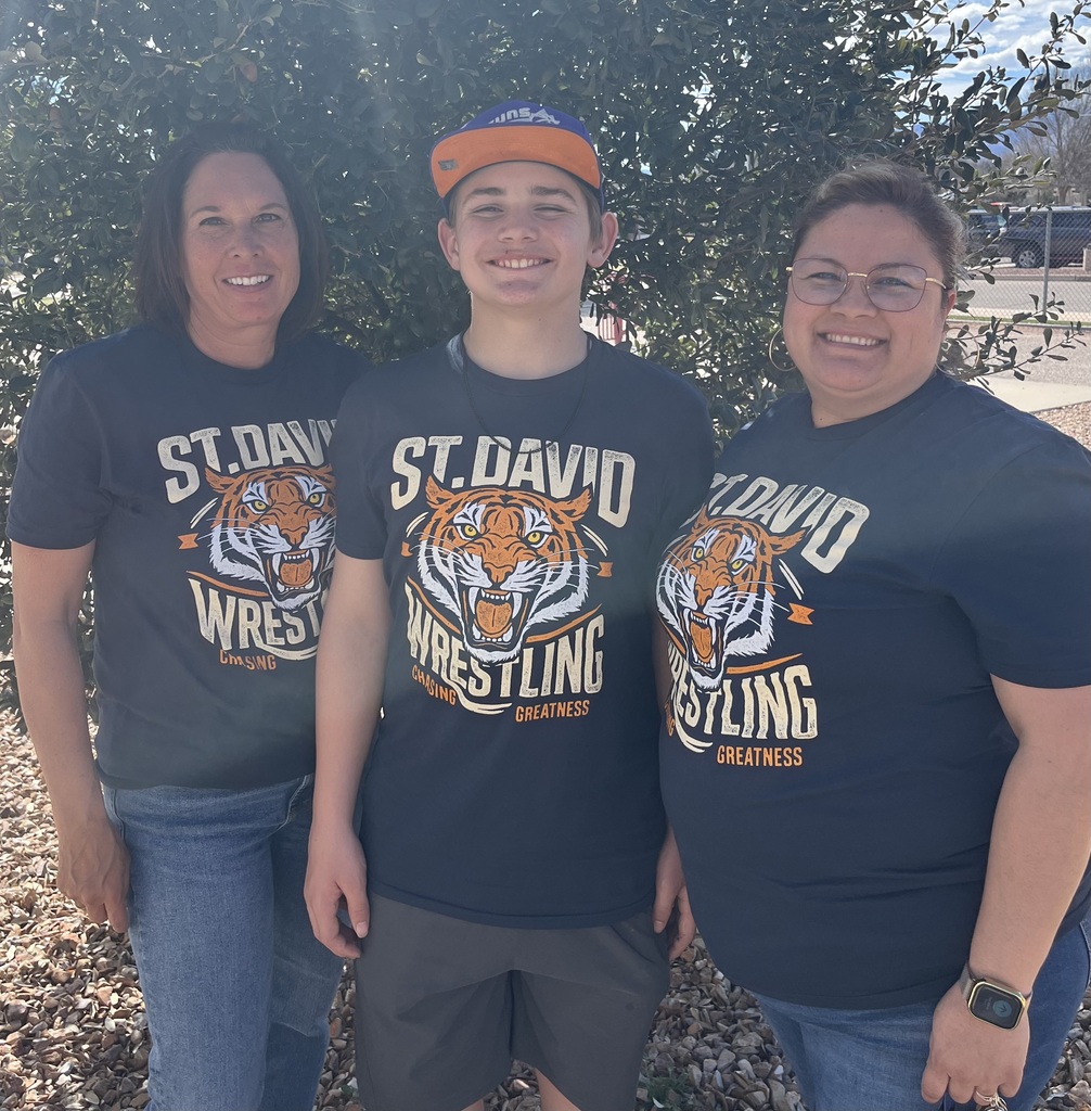 staff and student wearing wrestling shirt