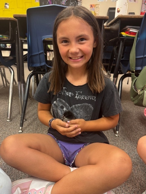 student holding chick