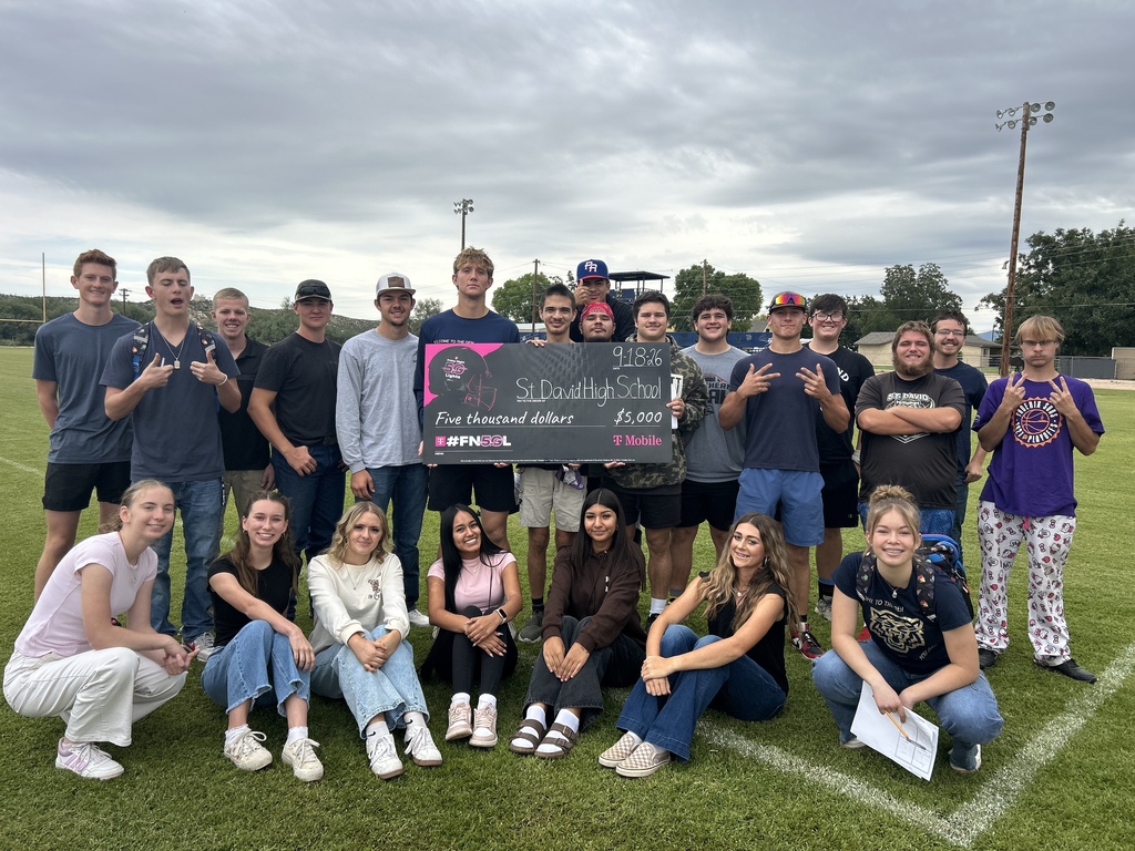 students holding winning check