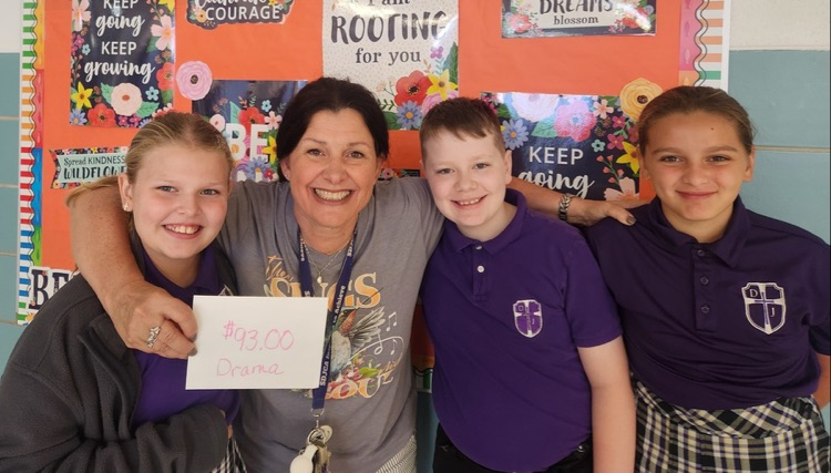 Aniela, Devon and Ellie making a donation to Mrs. Ray for the drama department.