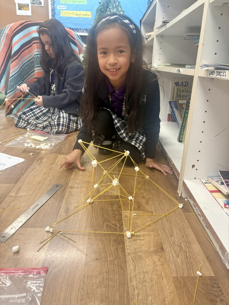 Remy Macalinga building her spaghetti tower!