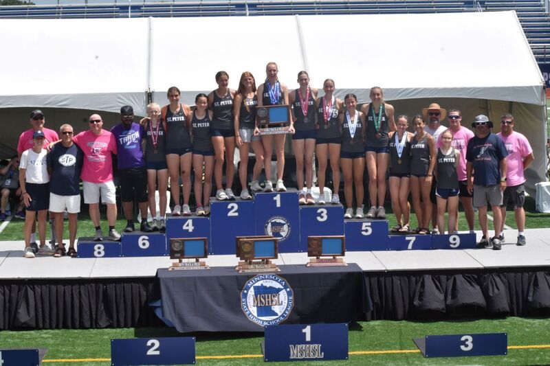 The Saints' girls track team receiving MN State AA runner-up trophy