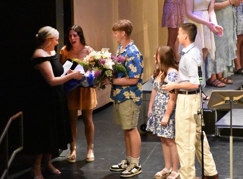 Bri Bergstrom receiving flowers from last year's seniors