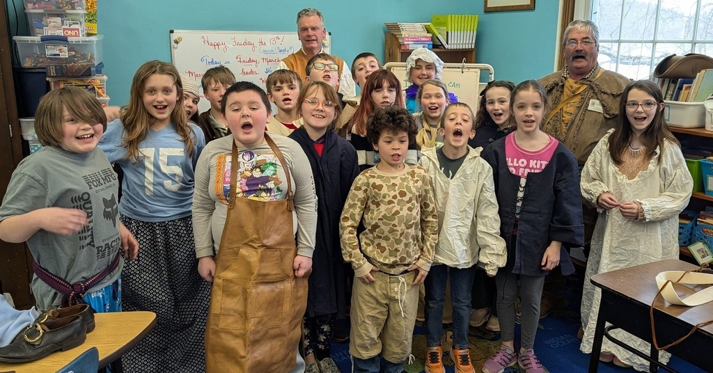 group of students posing with reenactors