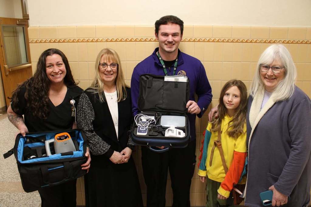 school nurses pose with health testing equipment