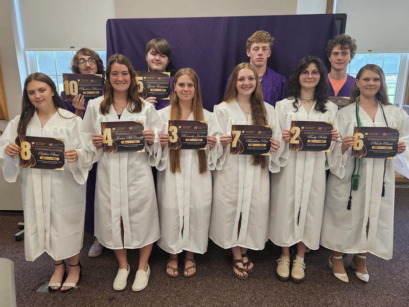 photo of the top ten graduates in purple and white graduating gowns