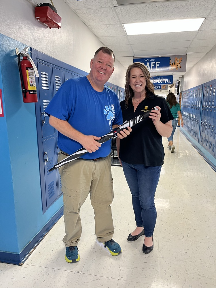 Sammi Parker brings umbrellas to William Lynch Elementary to donate on behalf of Town and Country Bank. She is pictured here with Dr. Herman Blau, the William Lynch Elementary School Principal.
