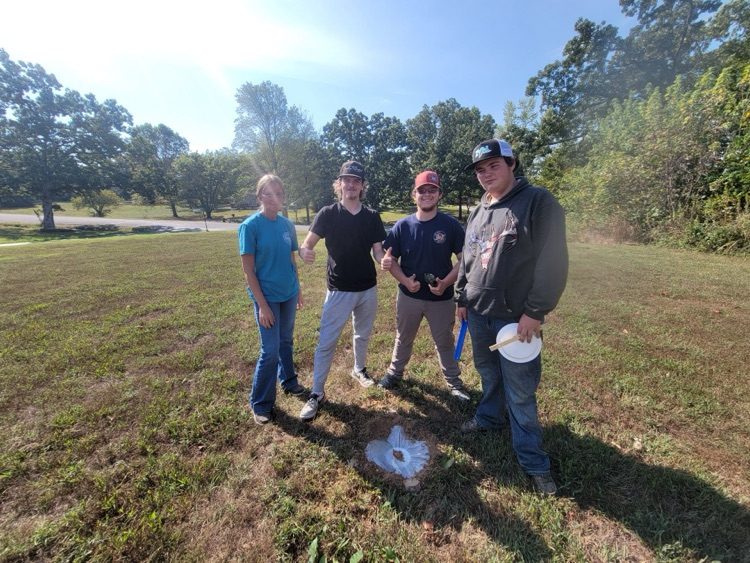 Ecology students making a water still