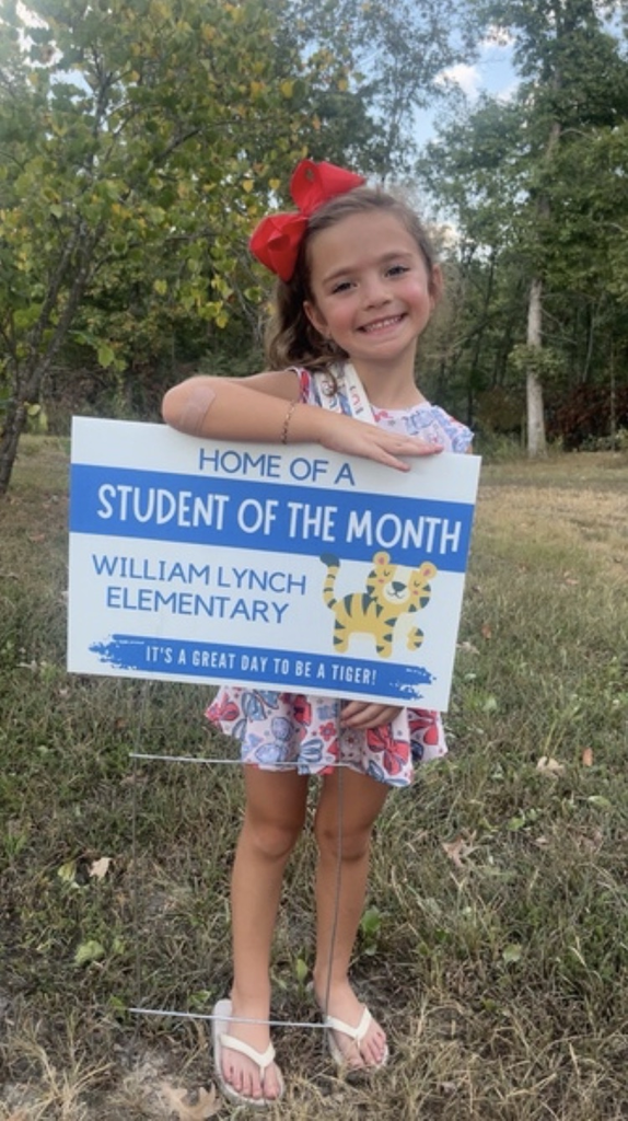 A September Student of the Month with her yard sign. 