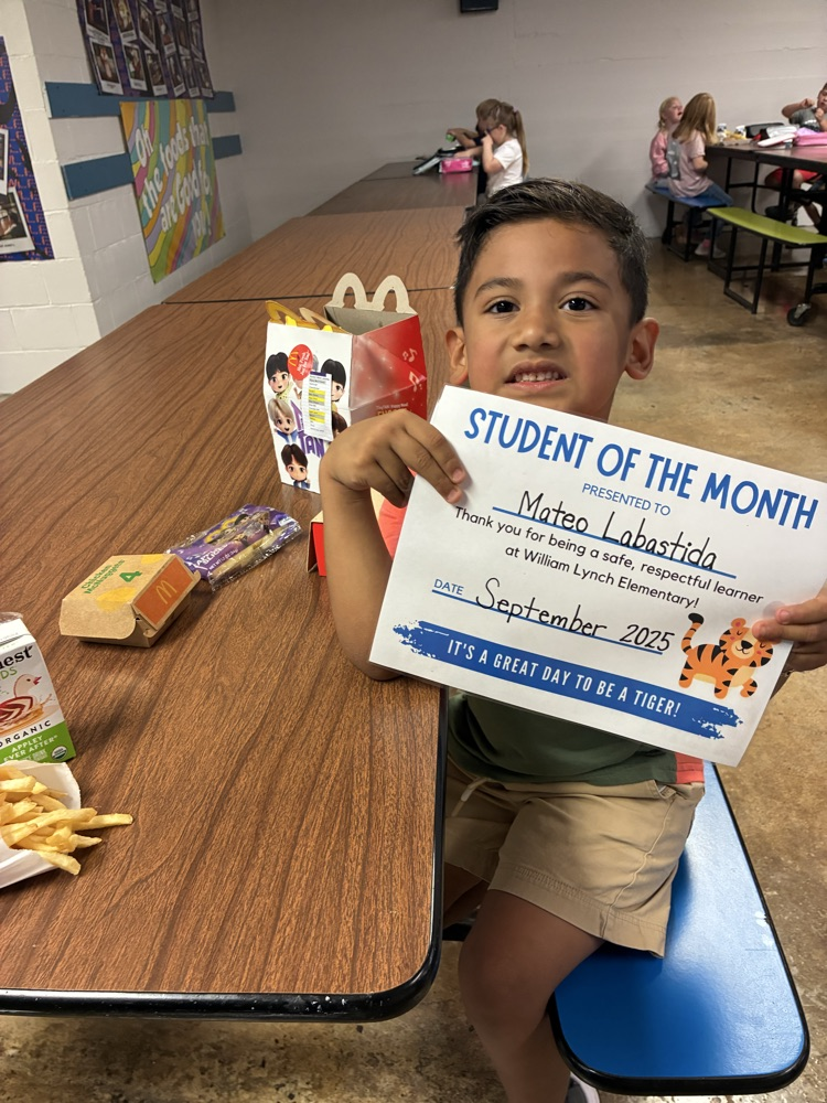 A kindergarten student of the month showing off his certificate! 