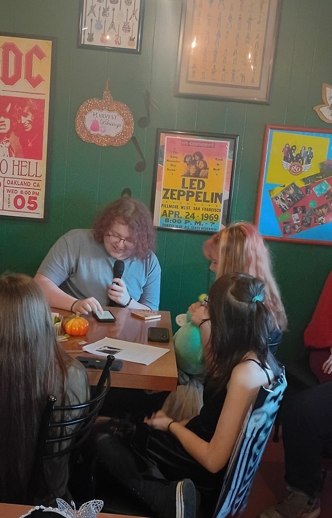 student reading a poem to another student