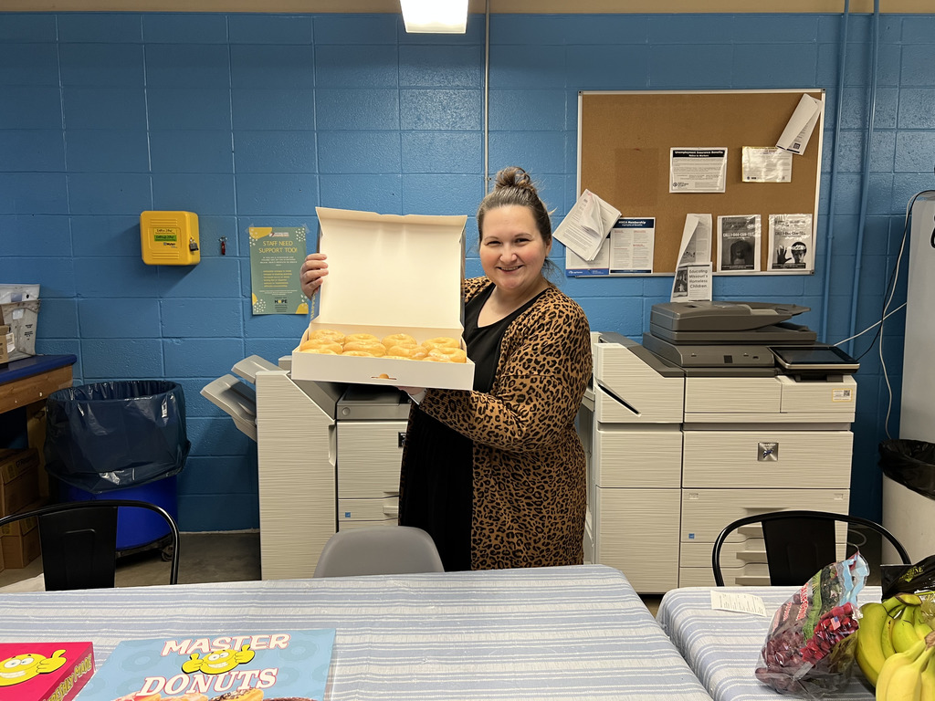 This is a picture of STUCO Advisor Mrs. Taylor putting out the donuts for staff members to enjoy this week.