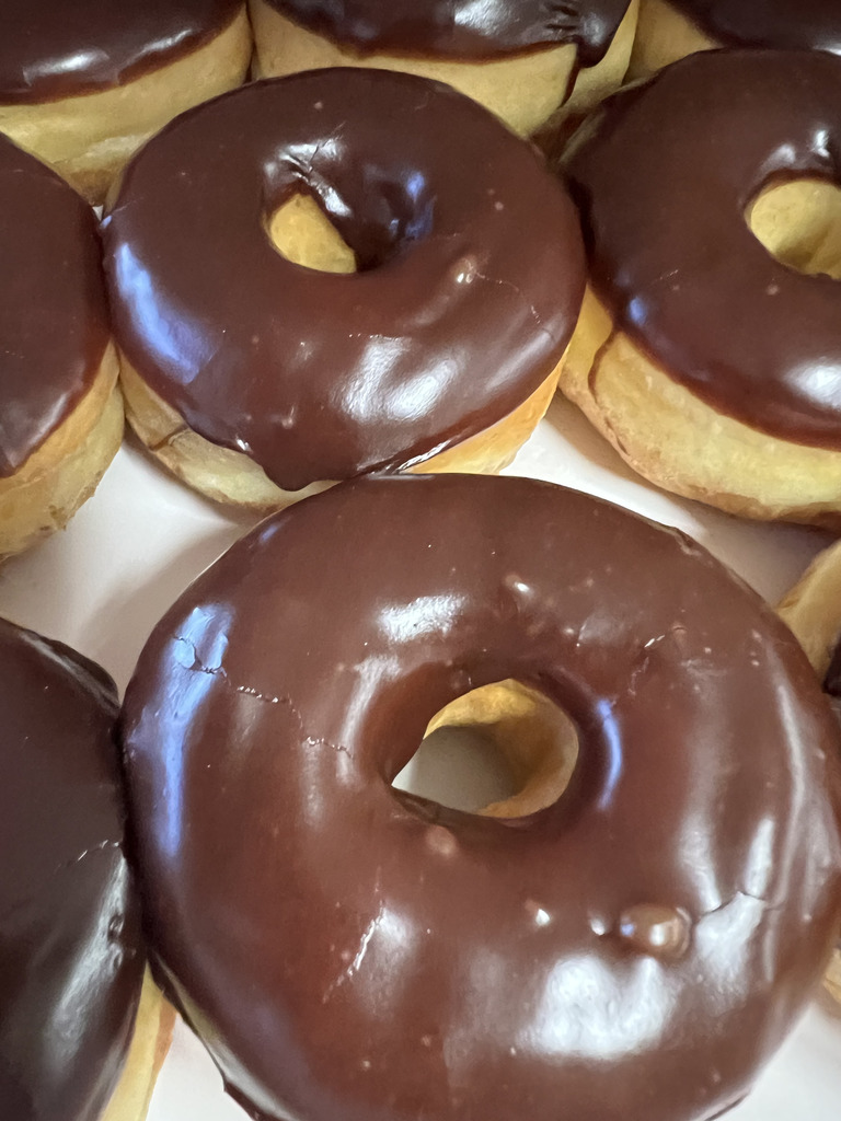 This is a picture of a box of chocolate glazed ring doughnuts from Master's Donut's in Salem, MO.