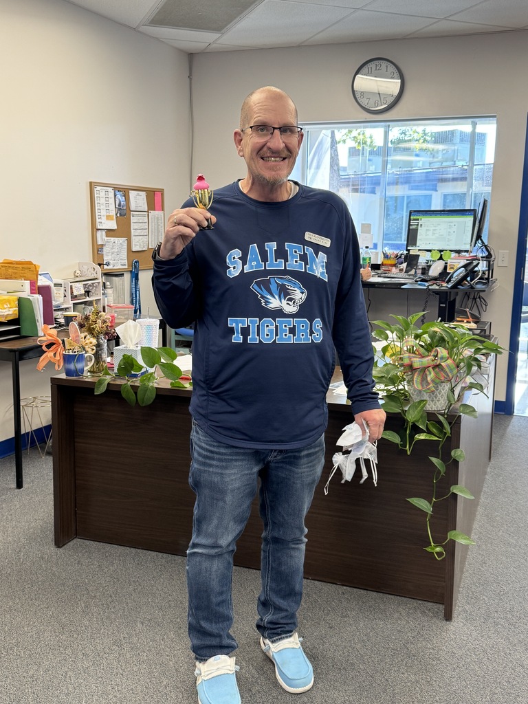 This is a photo of Mr. Overton with his third place trophy for getting four ducks during the Ducks and Doughnuts game.