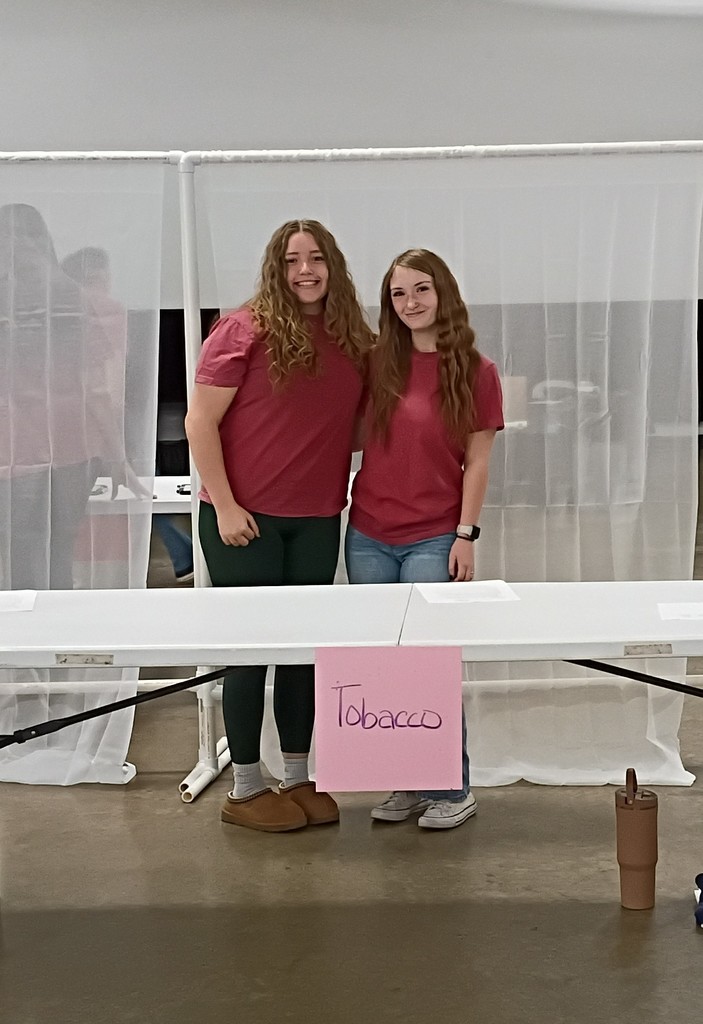 Students posing for a picture at the tobacco prevention station