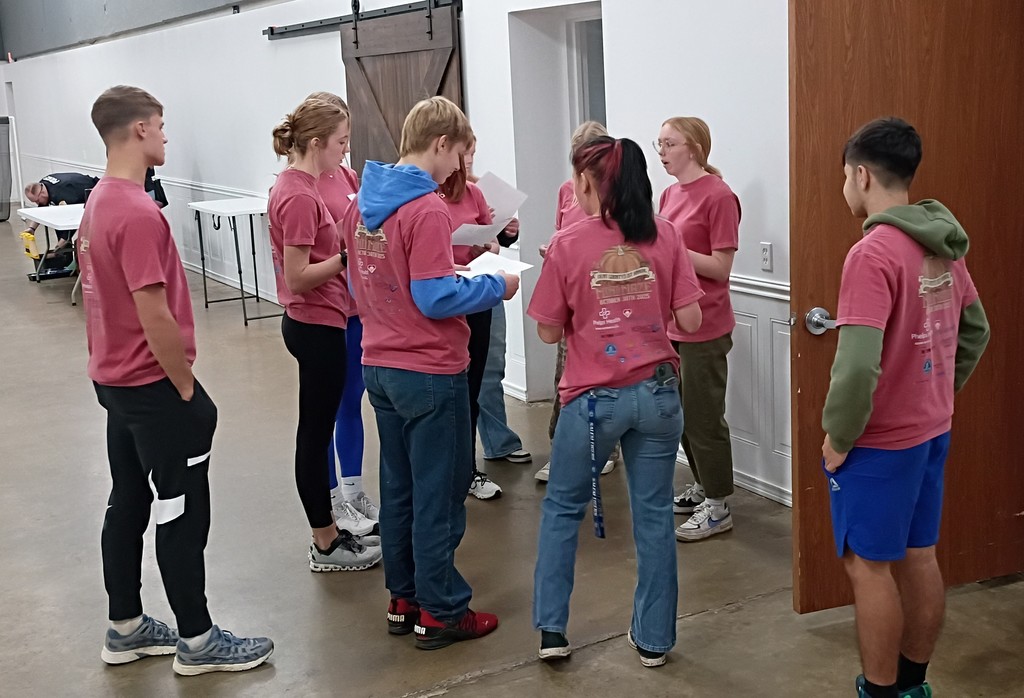 Students meeting to receive instructions from an adult. 