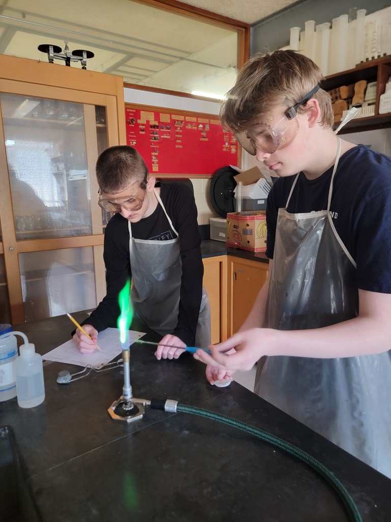 Students testing metals using a Bunsen Burner.