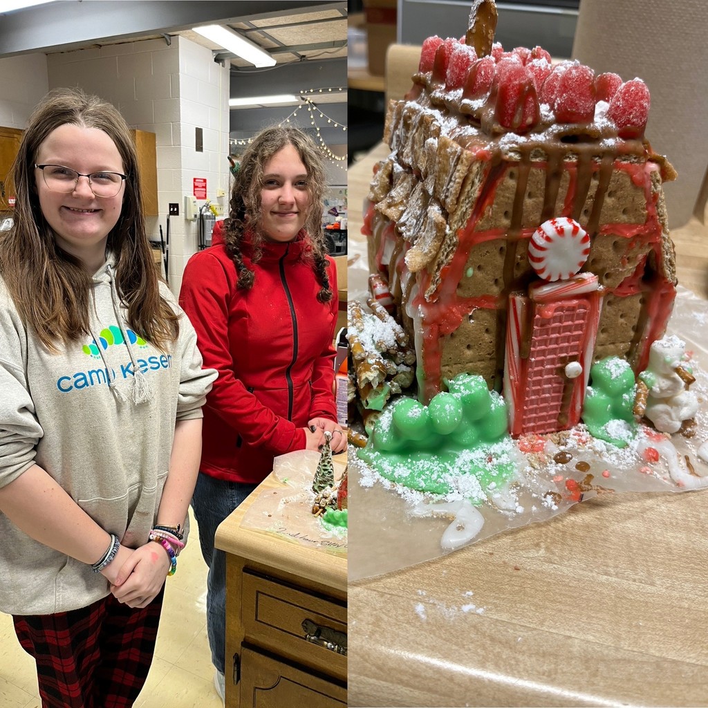 Students pose with their winning Gingerbread House creation.