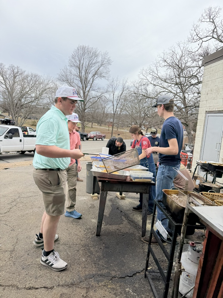 Students frying fish at the FFA Fish Fry