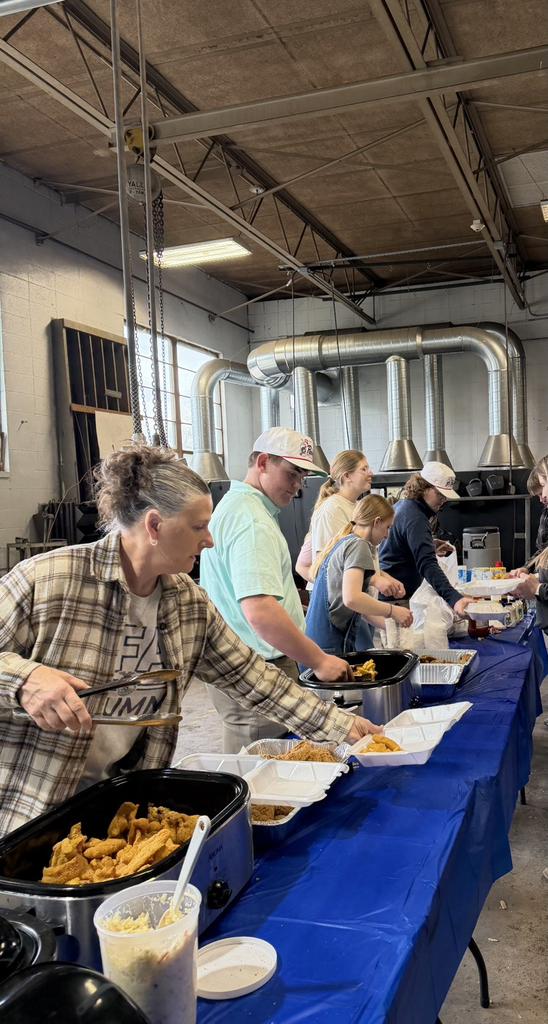 students and volunteers serving fish at the FFA Fish Fry