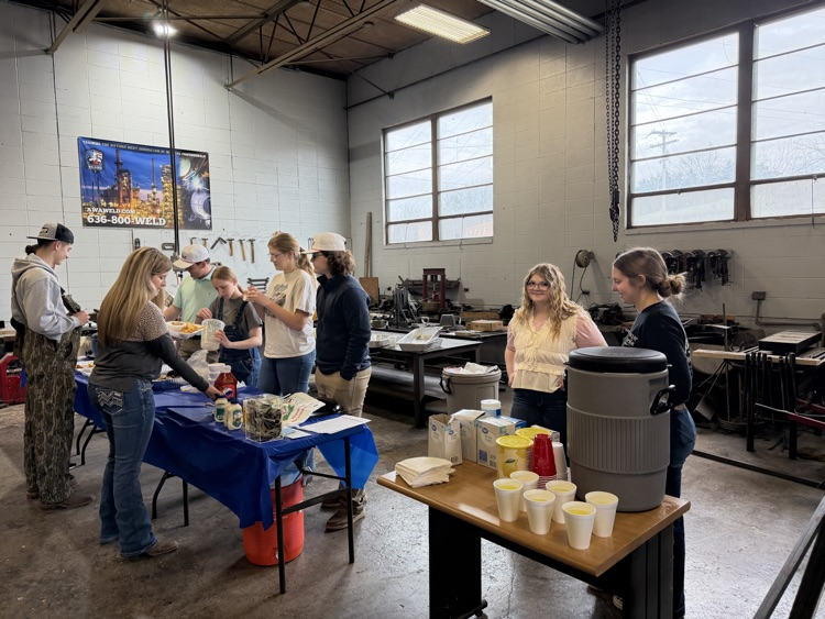 students and volunteers serving fish at the FFA Fish Fry