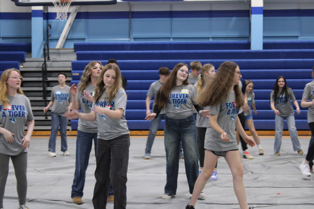 Students dancing in a gym.