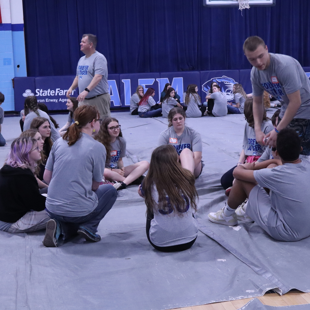 Group of students sitting in a circle. 