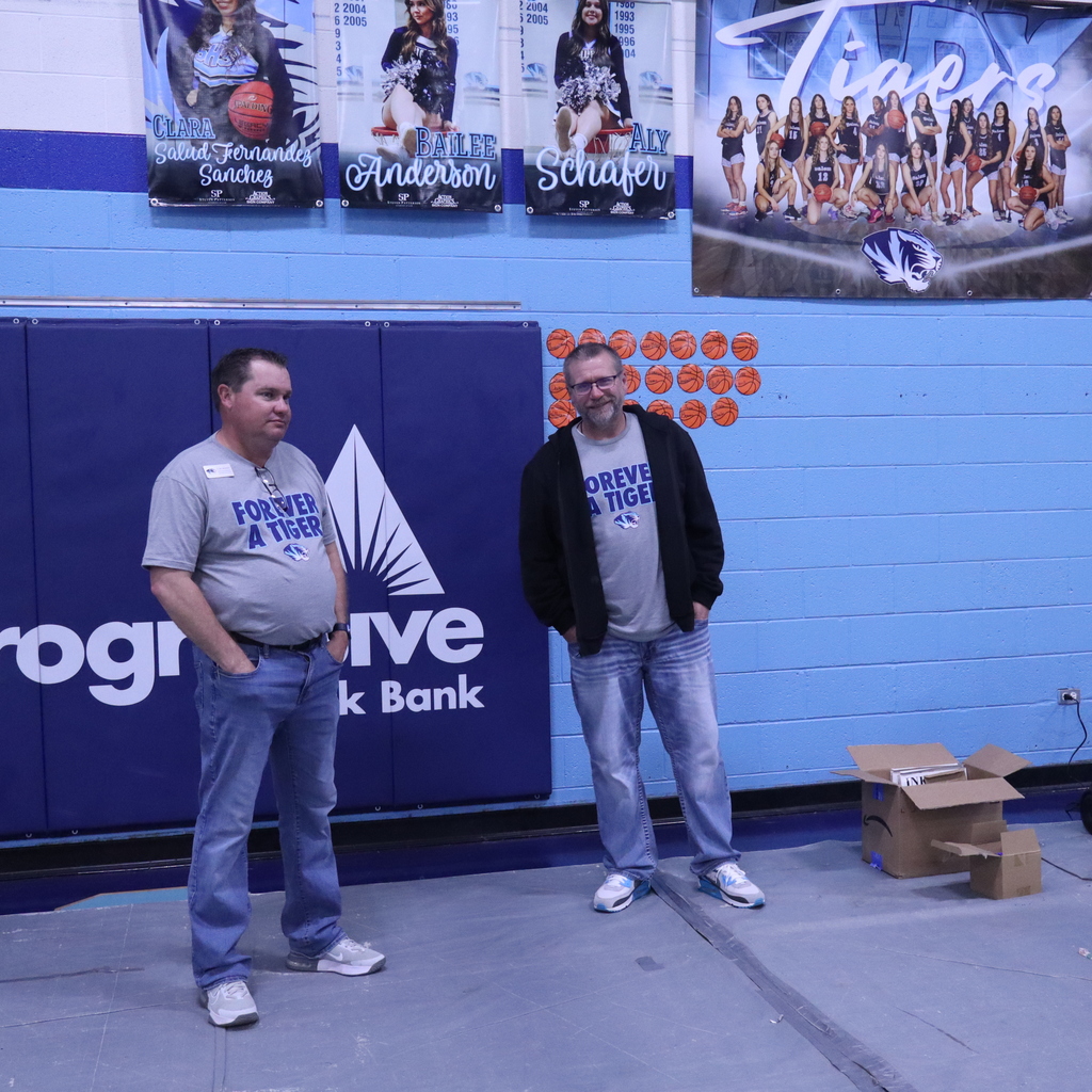 Two administrators standing in a gym