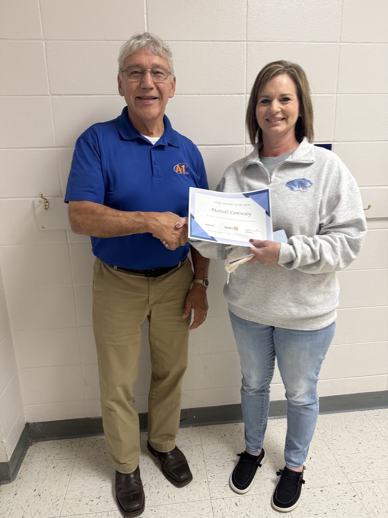 Mandi Conway receives Staff Member of the Year award from Jim Standfast. 