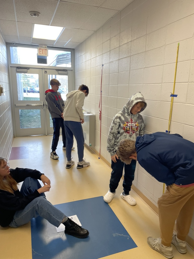 students measuring the bounce of a bouncy ball