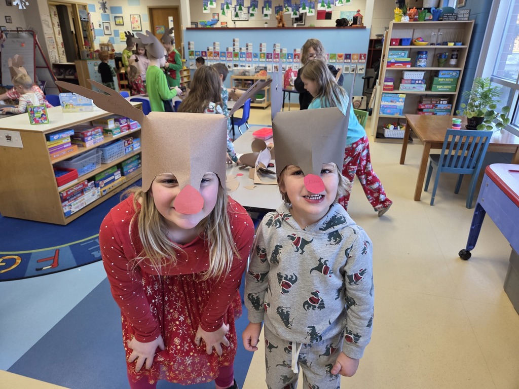  Two 3rd grade students wearing Rudolf hats