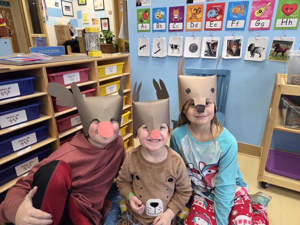 Three 3rd Grade students wearing Rudolf hats
