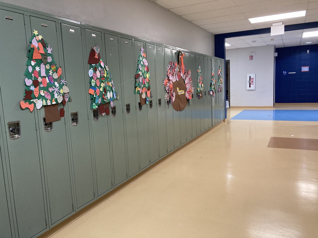 christmas trees on lockers with spanish on the ornaments created by students.