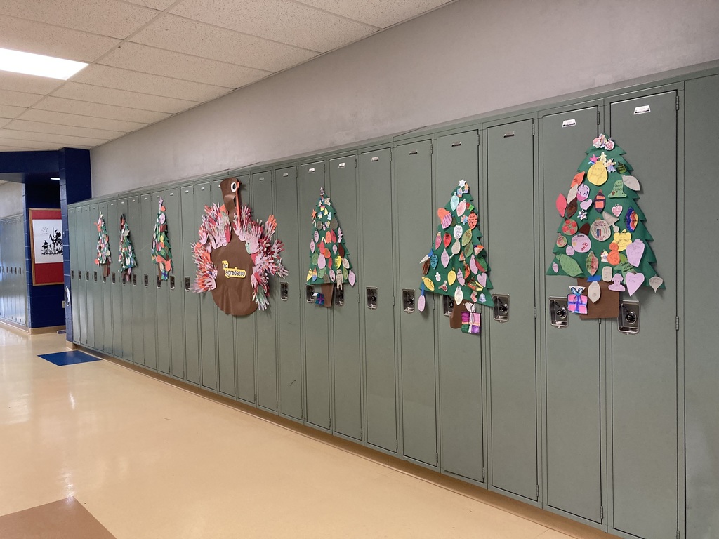 christmas trees on lockers with spanish on the ornaments created by students.