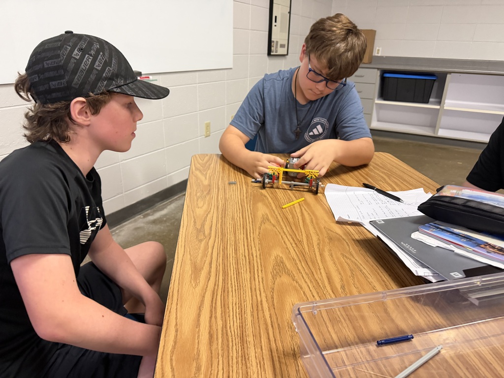 2 students are working together to design a car to race in PLTW robotics