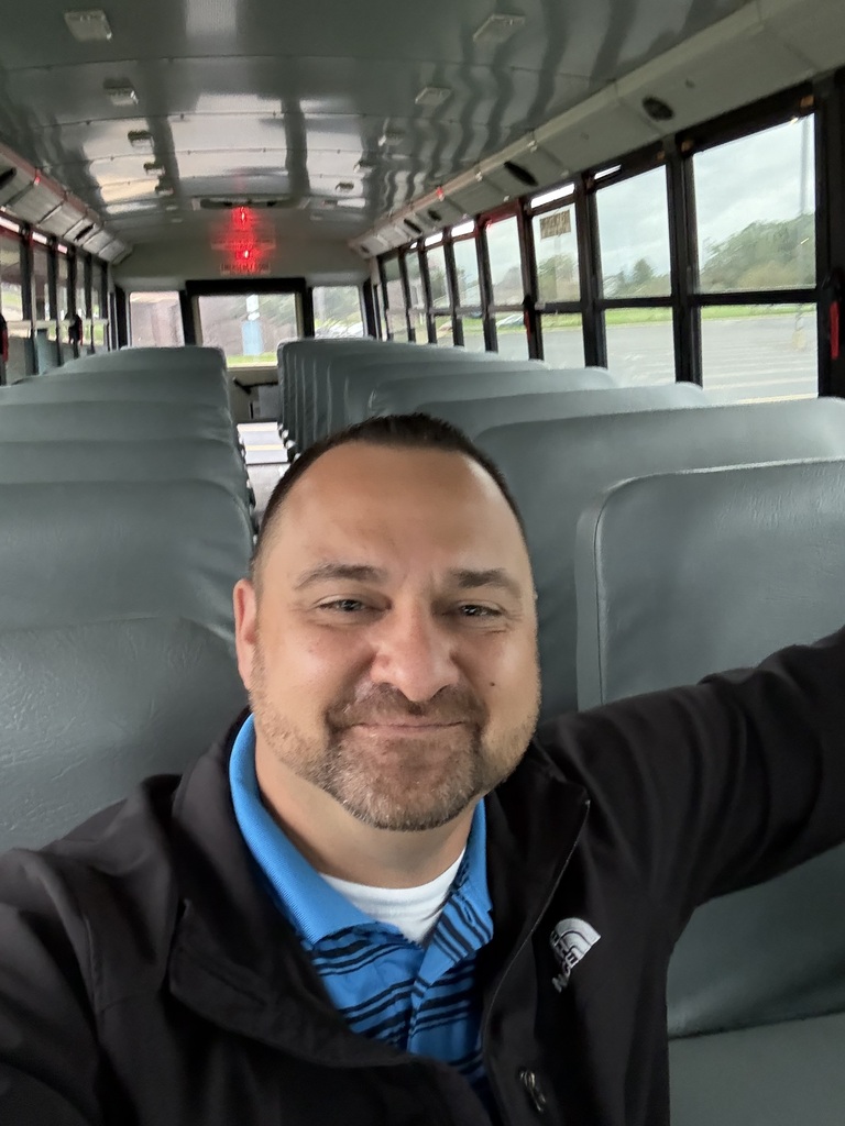 Mr. Norwick sitting on an empty school bus