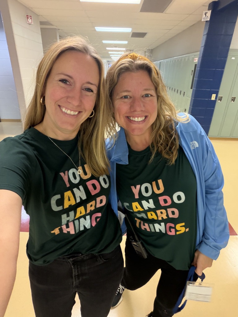 Ms. Panka and Ms. Powers in the hallway wearing t-shirts that say "You Can do hard things."