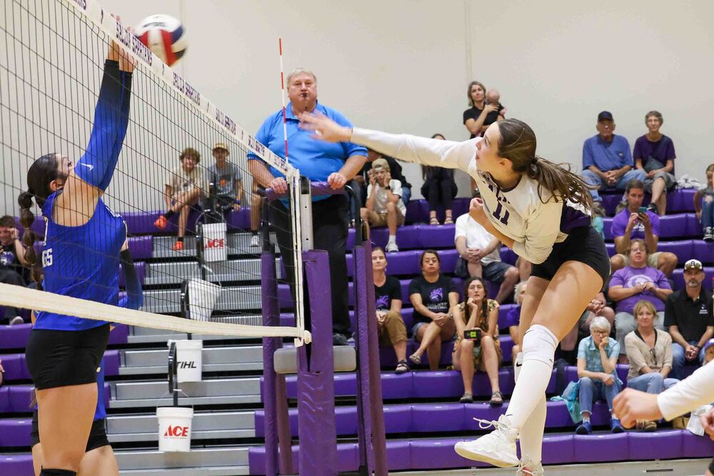 Volleyball Players at net.