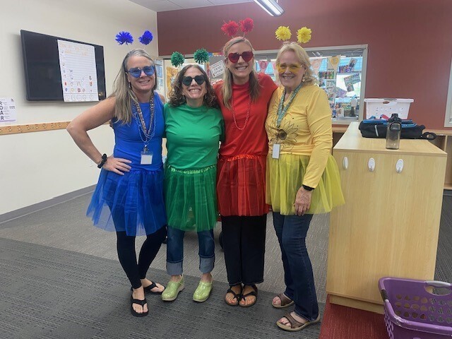 Longfellow Teachers sporting their house colors, red, yellow, green, and blue