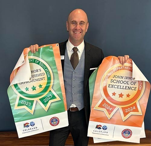 Superintendent Dr. David Blackburn with the award banners picked up from the CDE Awards Presentation for 2023 and 2024