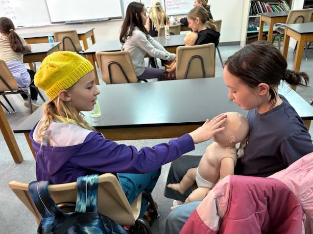 Caring for a babydoll in "Babysitting Bootcamp"