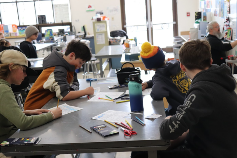 Students learning how to doodle from a Cartoonist
