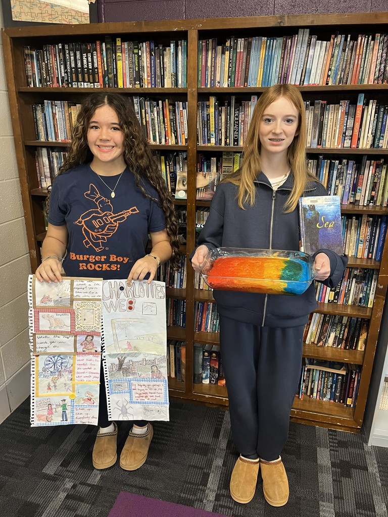 8th Grade students display baked goods and scrapbooks as part of second quarter book reports.